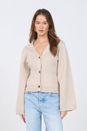 Beige knit cardigan with V-neck and buttons – women’s minimalist sweater.
