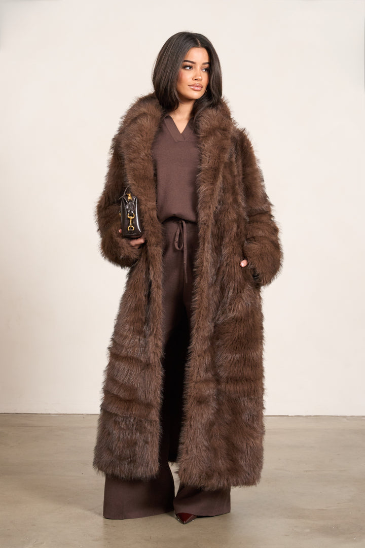 Woman in brown fur coat with monochrome brown outfit